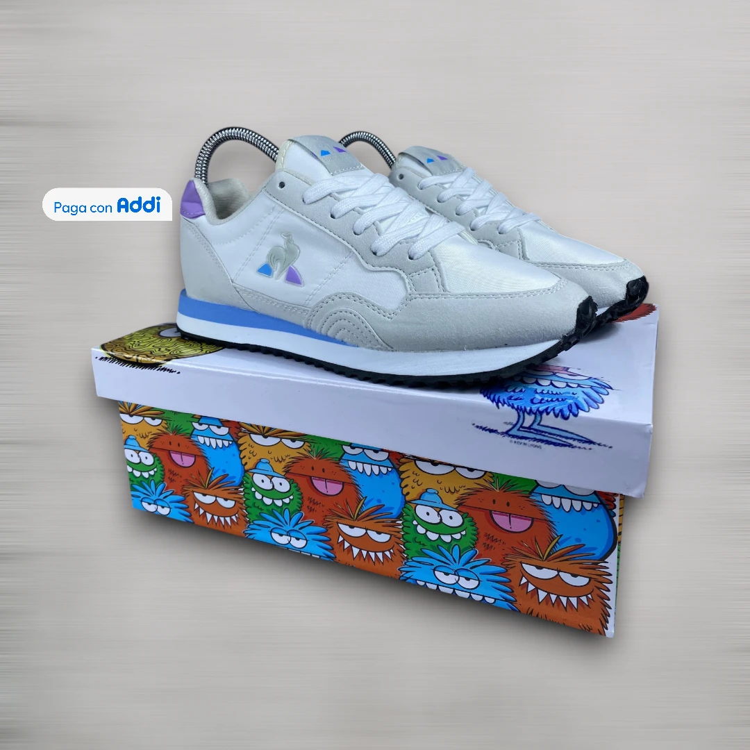 Tenis Le Coq Sportif blanco azul morado estilo casual urbano con diseño moderno y comodidad diaria