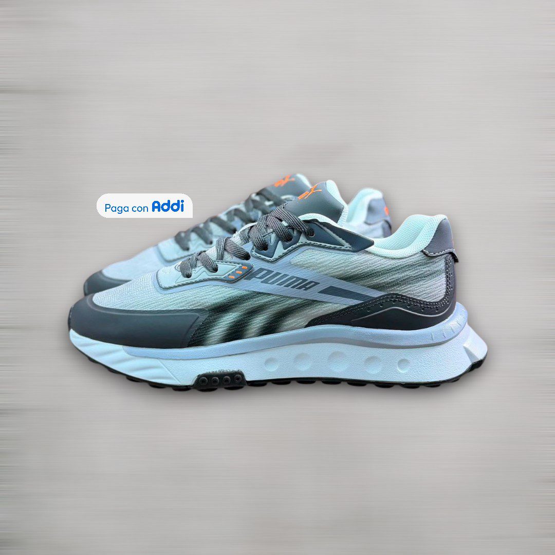 Tenis Puma Rider gris blanco estilo running urbano para caminar con amortiguación cómoda y diseño deportivo moderno